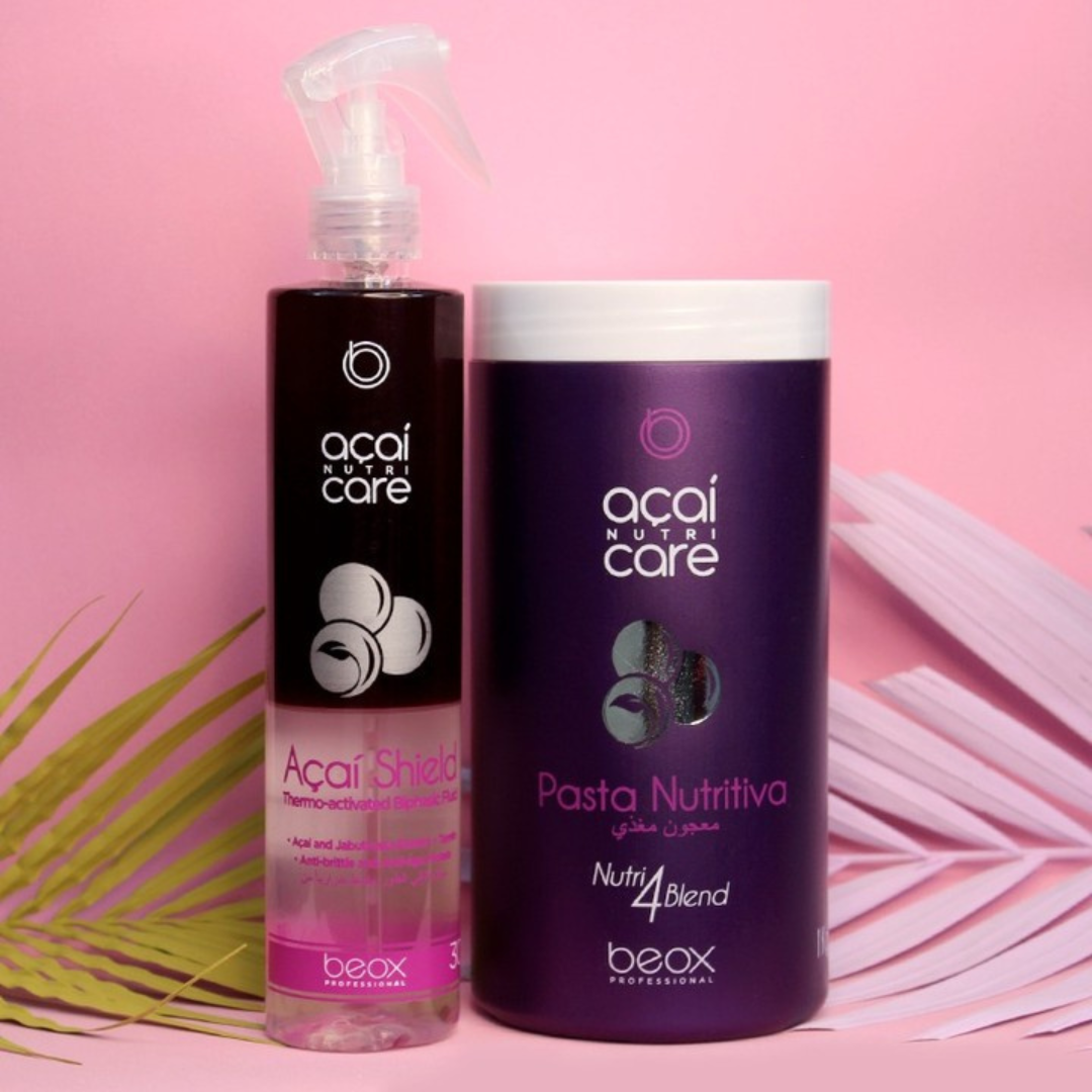 Two bottles of acai care hair products on a pink background with palm leaves.
